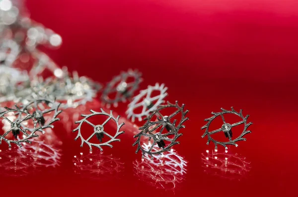 Watch Repair: Collection of Escape Wheels Resting in a Red Surface — Stock Photo, Image
