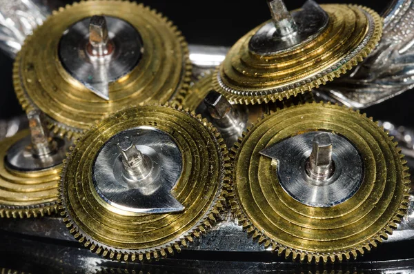 Watch Repair: Vintage Pocket Watch Fusee Cones Resting on a Black Surface