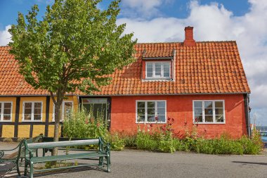 Danimarka 'nın Svaneke adasındaki Bornholm adasında geleneksel renkli yarı keresteli evler.