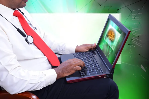 Young doctor with stethoscope and laptop — Stock Photo, Image