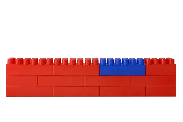 Red wall from blocks of the children's designer. One block is re — Stock Photo, Image
