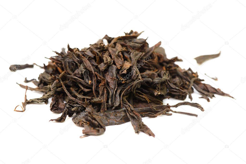 handful of dried leaves of black tea on a white background