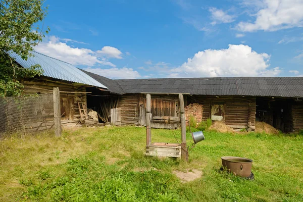 Corral con un granero de madera y un pozo —  Fotos de Stock