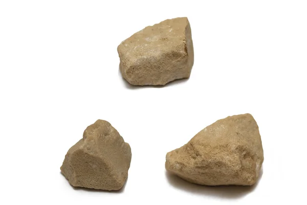 Three beige pebbles on a white background — Stock Photo, Image