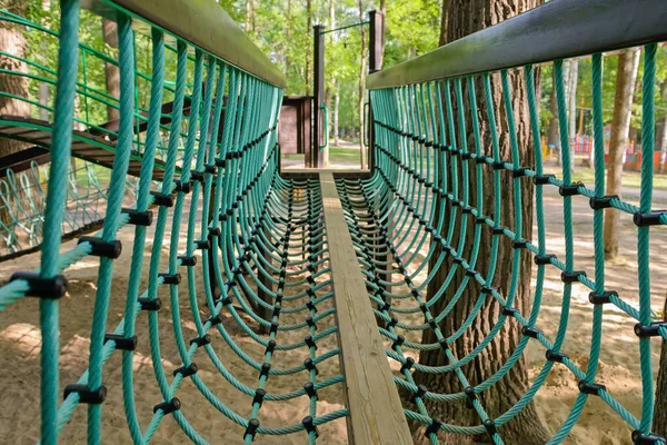 Parkta ağaçtan yapılmış çocuk parkı.