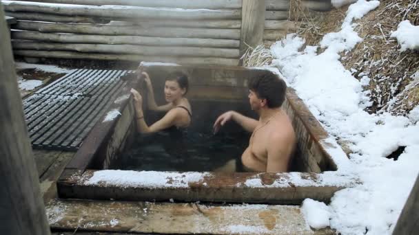 Prores codec. A man and a girl take a bath of hot natural mineral springs in the open in winter — Stock Video