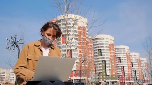 Jovem Mulher Roupas Marrons Uma Máscara Funciona Remotamente Com Laptop — Vídeo de Stock