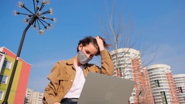 Emotional Young Woman Brown Clothes Mask Remotely Works Laptop Outdoors — Stock Video