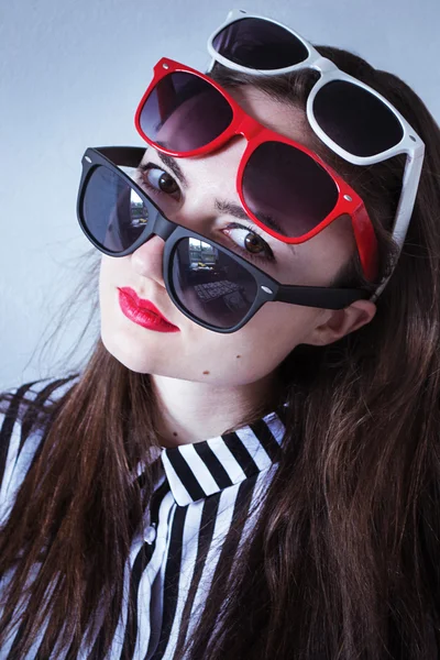 Photo portrait of a girl with glasses in three colors and a striped shirt Stock Photo