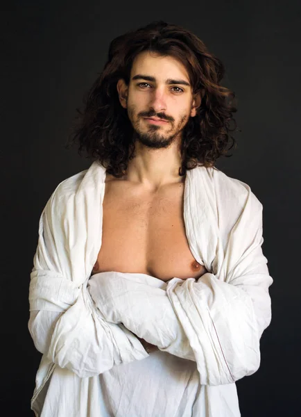 guy with long curly hair in a white drapery photo