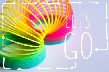 photo rainbow toy spring with painted graphics and text let's go clipart