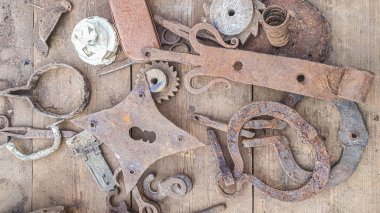 old rusty metal objects on a wooden table at a flea market