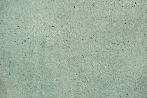 Açık yeşile boyanmış eski bir beton duvarın soyut arkaplanı
