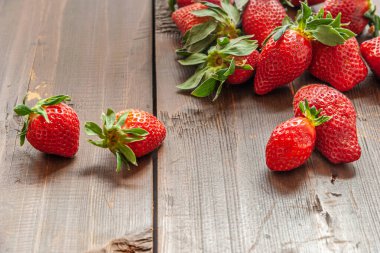 Ahşap bir yüzeyde kokulu çilekler.