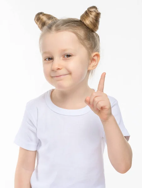 Little Blonde Smiles Slyly Shows Her Index Finger White Shirt — Stock Photo, Image