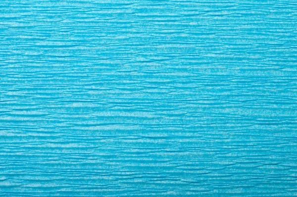 Background of turquoise pressed corrugated paper with a horizontal texture taken close up