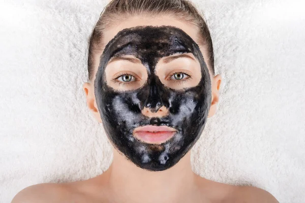 Beautiful Girl Black Mask Her Face Lying White Soft Towel — Stock Photo, Image