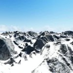 Aerial shot of snowy mountain peak