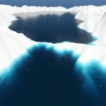 Aerial fly over iceberg and sea