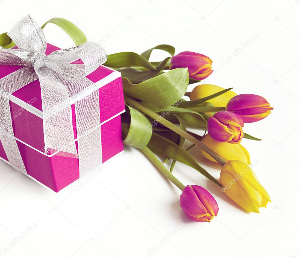 Red gift box with red and yellow tulip on white background with 