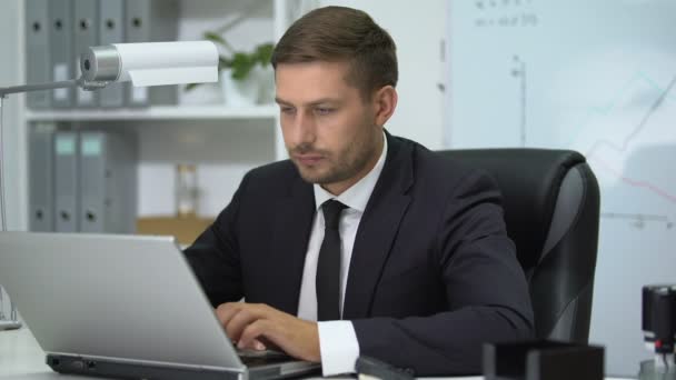 Figyelmes üzletember dolgozik laptop számítógép az irodában, modern technológiák — Stock videók