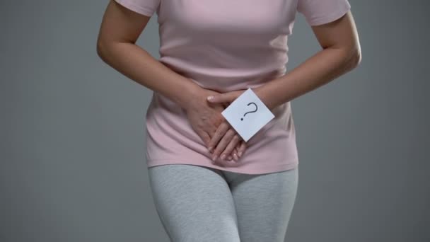 Lady with question mark sign on her hand touching belly, cystitis, dysmenorrhea — Stock Video