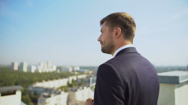 Glad company specialist celebrating work success drinking champagne on terrace — Stock Video