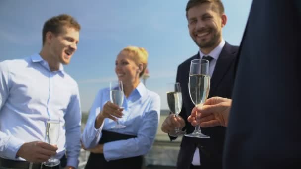 Happy office colleagues holding glasses celebrating work party rooftop, team — ストック動画