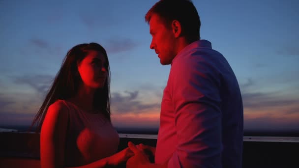 Молодая пара, держась за руки на террасе ночью расставание, недоразумение — стоковое видео