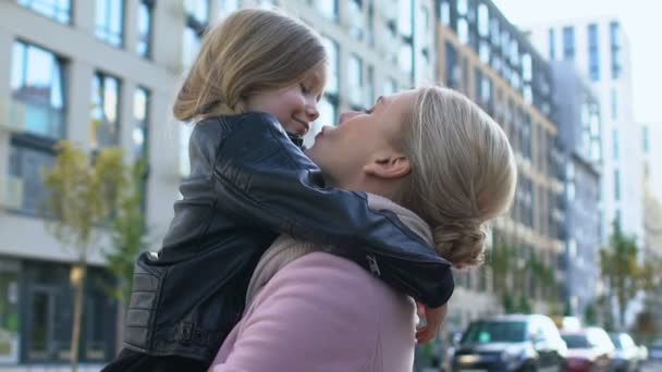 Mother kissing daughter nose holding child, family love expression, tenderness — Stock Video