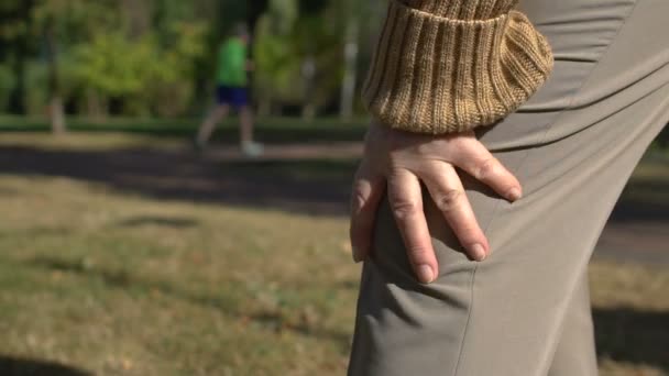 Vieille femme souffrant de douleurs au genou à l'extérieur, inflammation articulaire, arthrose — Video