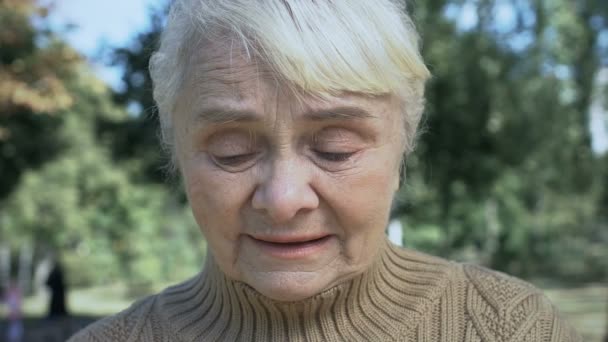 Mature unhappy woman crying outdoors, old age problems, loneliness despair — Stock Video