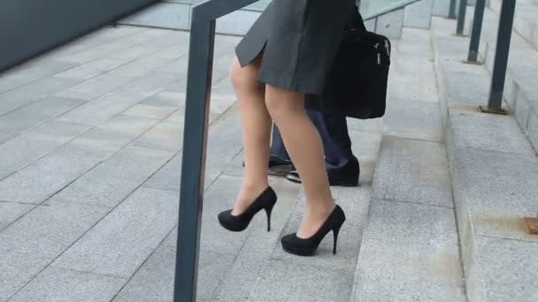 Man and woman walking downstairs after busy day in office, visiting partners — Stock Video