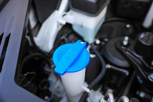 Car windshield washer fluid cap. Close up and top view image of reservoir washer bottle cap.
