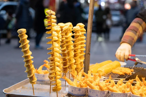 Venta de Patatas Tornado Coreanas en Myeongdong, Corea del Sur. Comida callejera coreana, Potato twister . Imágenes De Stock Sin Royalties Gratis