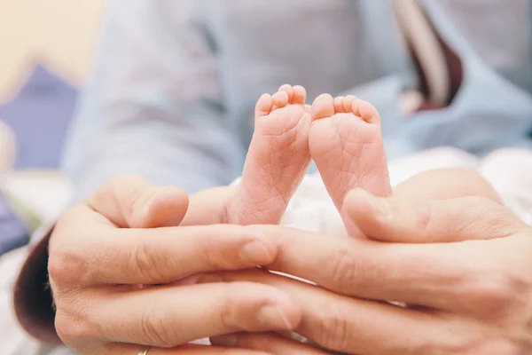 Little infant newborn child in maternity hospital on his fathers