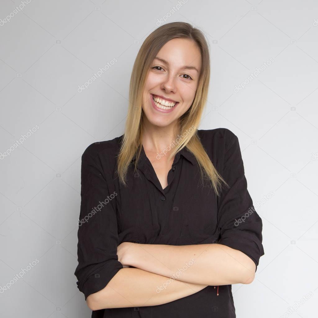 Beautiful brunette caucasian woman in dark black blouse with bri