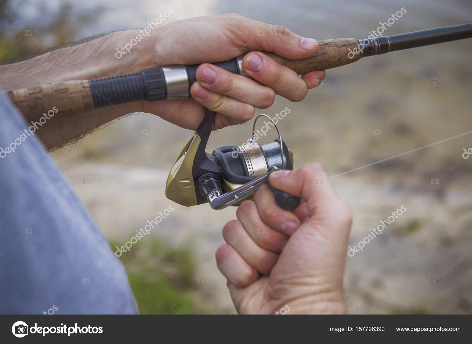 Young handsome brutal caucasian man in casual outfit fishing on a