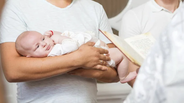 Godfather (caucasian young man) holding little infant kid in bap — Stock Photo, Image