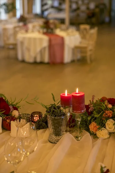 Conjunto de velas de cor de vinho em uma mesa de casamento cercada por luz — Fotografia de Stock