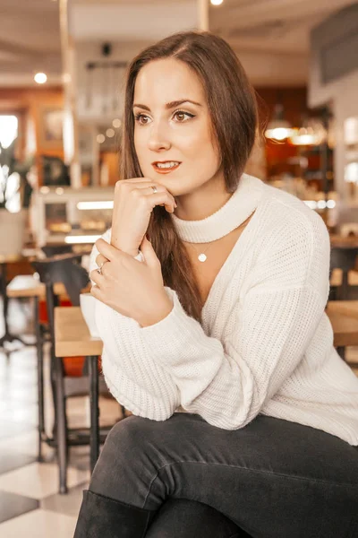 Morena joven mujer caucásica en suéter casual y jeans sitti —  Fotos de Stock