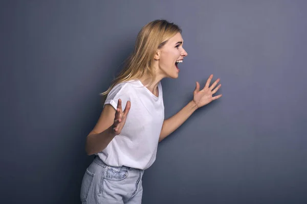 Caucasian woman in neutral casual outfit standing on a neutral g