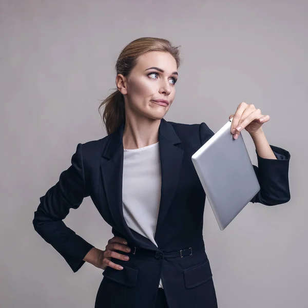 Kaukasische erwachsene Frau im Business-Outfit auf einem neutralen grauen Rücken — Stockfoto