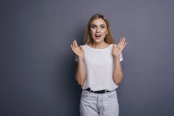 Caucasian woman in neutral casual outfit standing on a neutral g