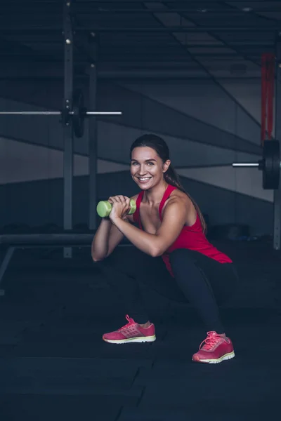 Slim fit muscular morena ejercicio de mujer en el gimnasio, levantamiento de peso — Foto de Stock