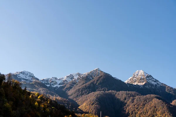 snowy mountain peaks in autumn