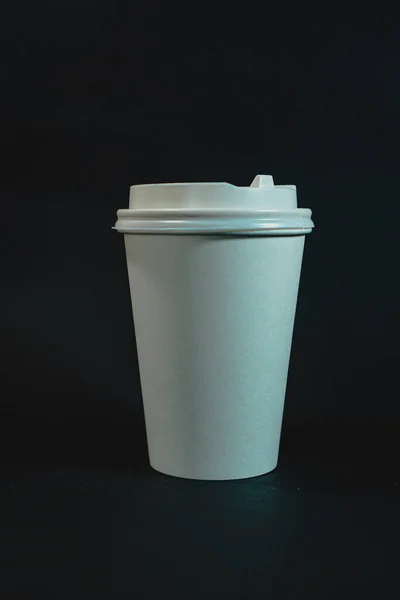 white plastic cup on a black background