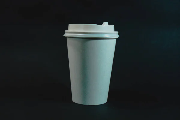 white plastic cup on a black background