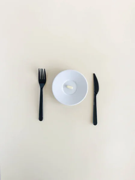 One White Tablet Lies Plate Next Cutlery Knife Fork — Stock Photo, Image