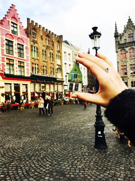 magnet in the hand of a girl on a square in Bruges in Belgium